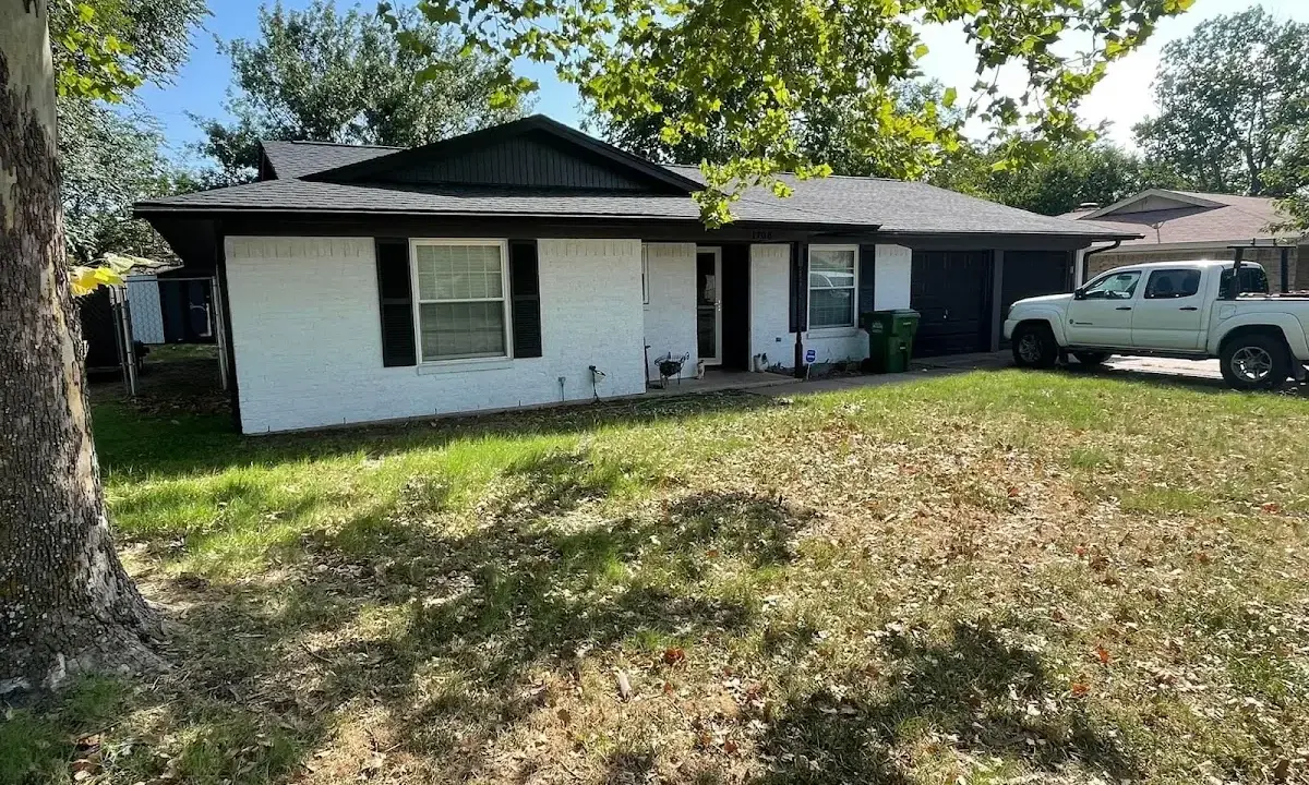 Professional roofing crew working on a residential roof in Carrollton
